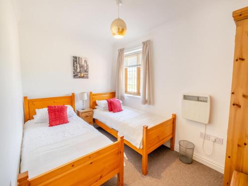 a bedroom with two beds and a window at Fair Isle Holiday Cottages - Hill Top Cottage in Newport