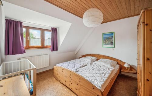 a bedroom with a wooden bed in a room at Cozy Apartment In Rechlin With Wi-fi in Rechlin