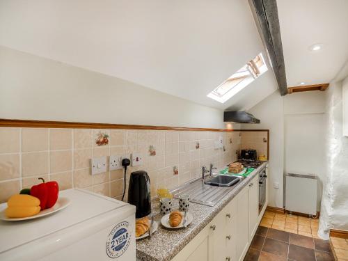 a kitchen with a sink and a counter top at Ty Canol in Llanfaelrhys