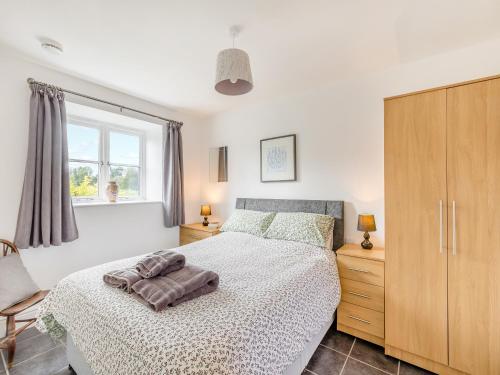 a bedroom with a bed and a large window at Overshot - Uk45388 in Crewkerne