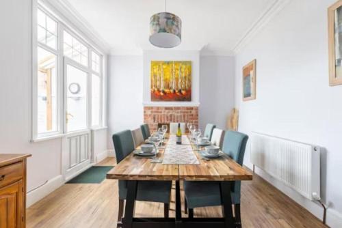 a dining room with a long table and chairs at Paradise House Darlington in Darlington