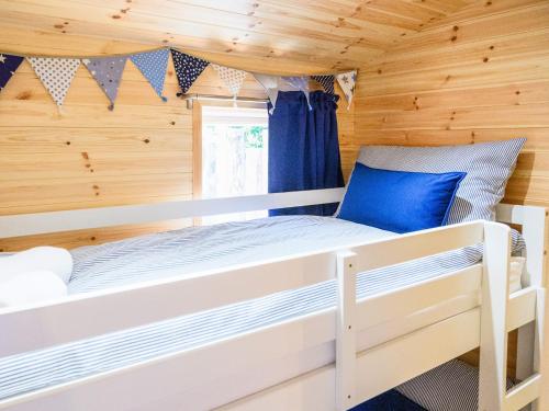 a bedroom with a bunk bed in a wooden cabin at Orchard Cabin-rowan - Uk45435 in Isle of Whithorn