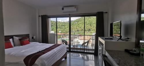 um quarto com uma cama e vista para uma varanda em DB Studios Samui em Lamai