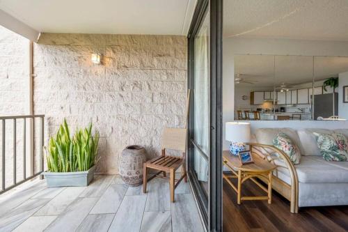 a living room with a couch and a table at Kihei Alii Kai D207- Ocean view, walk to shops, dining, and Kam I Beach in Kihei