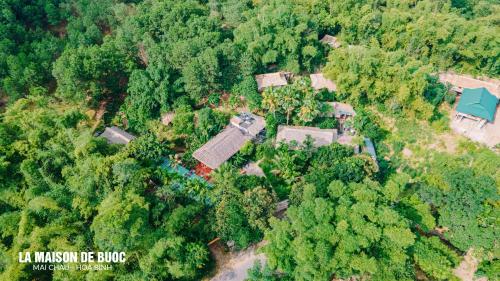 an aerial view of a house in the forest at La Maison De Buoc in Mai Chau
