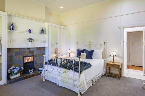 a bedroom with a bed and a fireplace at Amongst the Vines Deluxe Retreat in Blewitts Springs