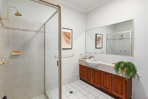 a bathroom with a shower and a sink at The Golden Whistler Montville in Montville
