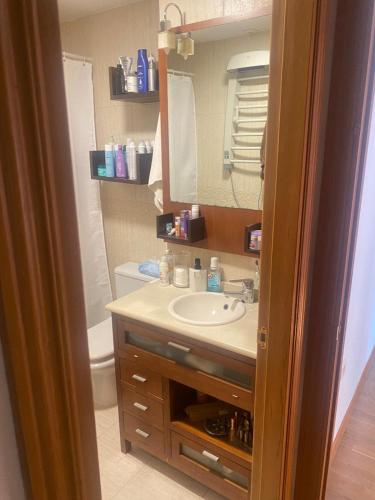 a bathroom with a sink and a mirror at Habitación Almería capital in Almería