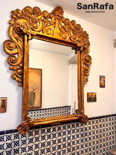 an ornate mirror on a wall in a bathroom at Casa SanRafa in Mexico City