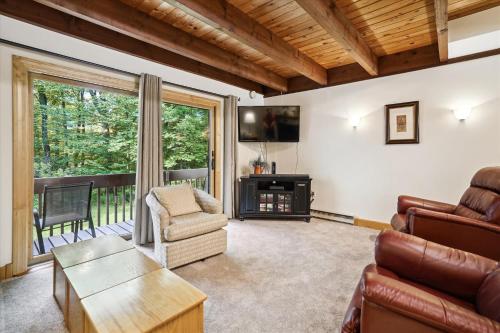 a living room with a couch and a chair at Ski home on the trail from Showshed! Or take the free shuttle A2 in Killington