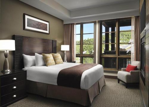 a bedroom with a large bed and a large window at Hyatt Vacation Club at Northstar Lodge in Truckee