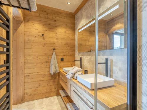 a bathroom with a sink and wooden walls at Appartement Les Arcs 1600, 5 pièces, 12 personnes - FR-1-461A-15 in Arc 1600