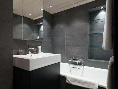a bathroom with a white sink and a mirror at Duplex 4 pers à Courchevel 1850 – Luxe et confort au pied des pistes - FR-1-631-175 in Courchevel