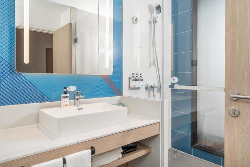 a bathroom with a sink and a shower at Holiday Inn Express Dandong City Center, an IHG Hotel in Dandong