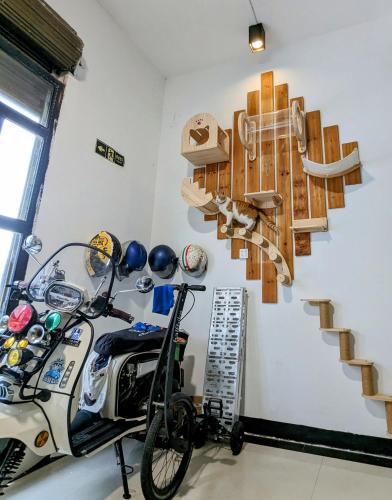 a room with a bike parked next to a staircase at Meow! Marcia Youth Hostel in Pingtan