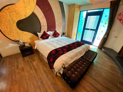 a bedroom with a large bed and a couch at The Domed Tile B&B in Magong