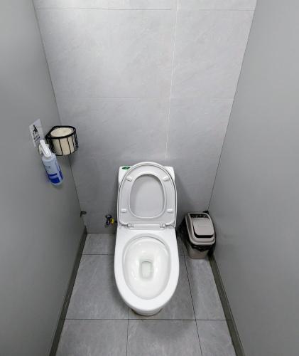 a small bathroom with a toilet in a stall at Meow! Marcia Youth Hostel in Pingtan