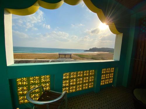a view of the ocean from a room with a window at The Domed Tile B&B in Magong