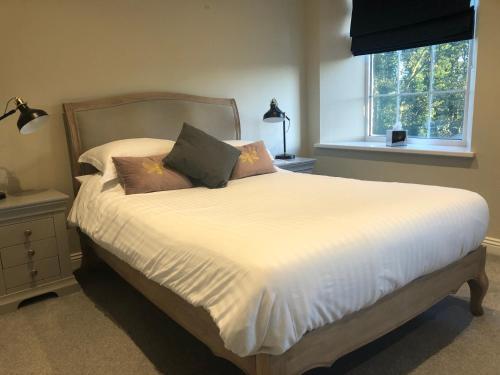 a bedroom with a bed with white sheets and pillows at The Fox Hall Inn in Richmond