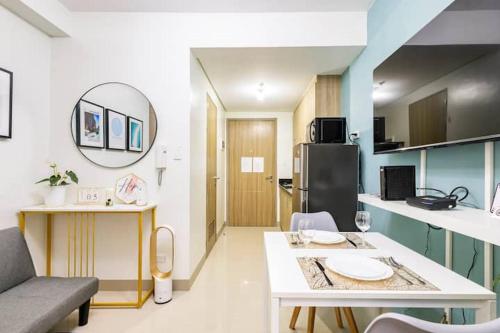 a small kitchen with a table and a room with a kitchen at Shore 2 Residences 1BR Deluxe Room in MOA Complex in Manila