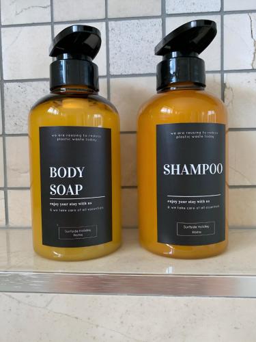 two bottles of soap sitting on a shelf at 100m to Beach&Shop Spacious Pristine One Story Family Home in Batemans Bay
