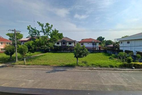 an empty street in a residential neighborhood with houses at Home in Bacolod in Bacolod