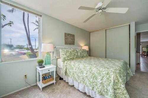 a bedroom with a bed and a large window at Hale Kamaole 7-169- Ground floor, ocean view, updated Kihei gem in Wailea
