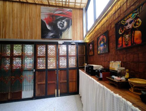 a room with wooden walls and glass doors and a counter at Rinvada House in Bangkok