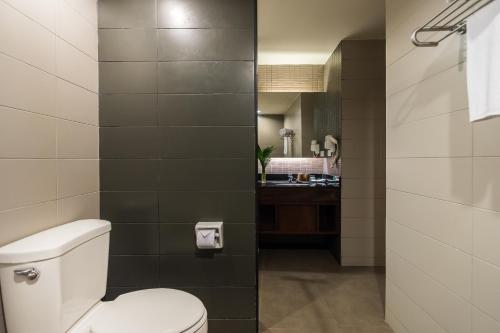 a bathroom with a toilet and a sink at Sea Me Spring Hotel in Pattaya