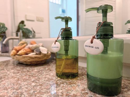 two bottles of soap sitting on top of a counter at À La Koh Kood Resort in Ko Kood