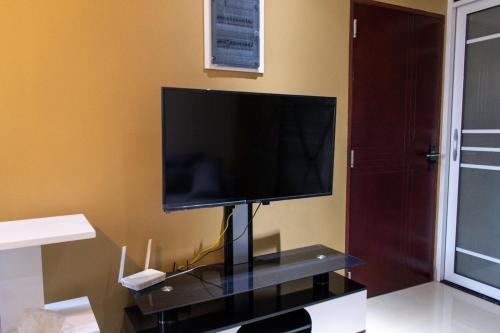 a flat screen tv on a stand in a room at Fanfini Residence Male’ in Male City