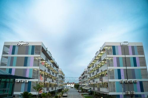 two tall apartment buildings on a city street at Zaque's Hotel in Sungai Petani
