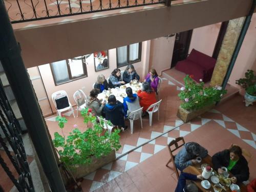 a group of people sitting at a table in a room at Hostal Juanita in Vallegrande