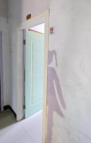 a door in a room with a door with a window at Meow! Marcia Youth Hostel in Pingtan