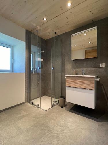 a bathroom with a shower and a sink at Ferienhaus Capricorn **** in Saas-Grund