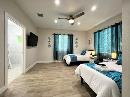 a bedroom with two beds and a tv in it at New & Modern with Accessibility-Family Friendly in San Bernardino