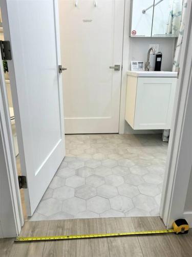 a kitchen with a yellow tape on the floor at New & Modern with Accessibility-Family Friendly in San Bernardino
