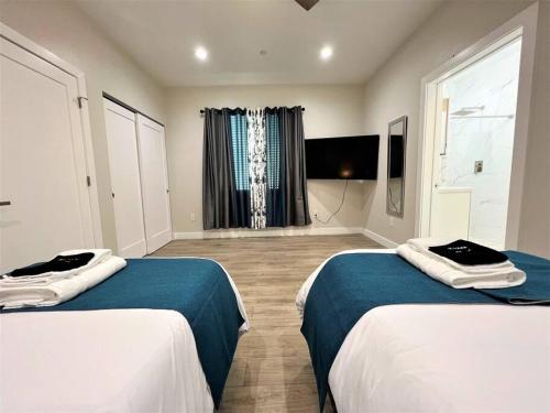a hotel room with two beds and a window at New & Modern with Accessibility-Family Friendly in San Bernardino