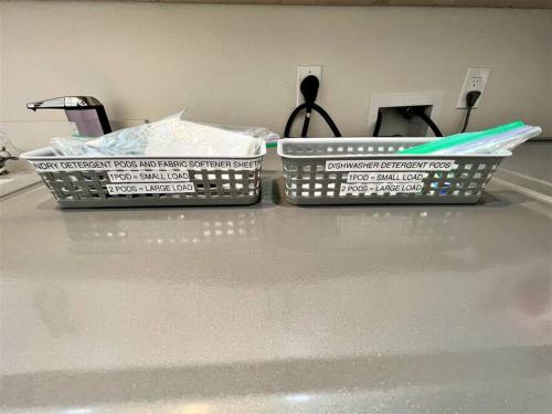 two plastic containers sitting on a counter top at New & Modern with Accessibility-Family Friendly in San Bernardino