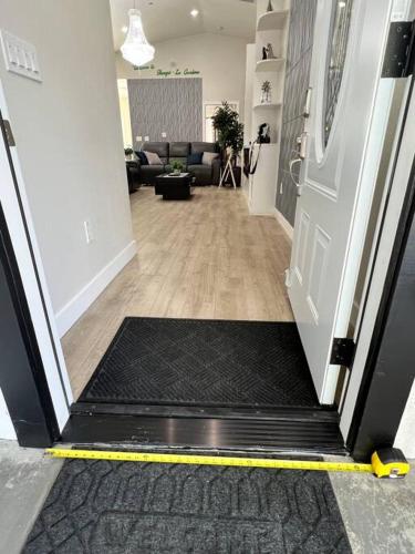 a room with a door with a mat on the floor at New & Modern with Accessibility-Family Friendly in San Bernardino