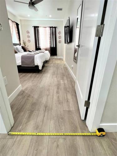 a room with a bed and a yellow measuring tape at New & Modern with Accessibility-Family Friendly in San Bernardino