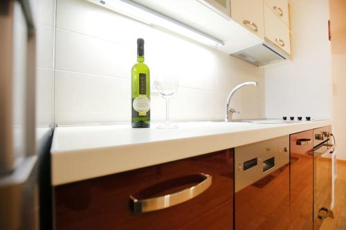 a bottle of wine sitting on top of a kitchen counter at Apartment Marty in Zadar