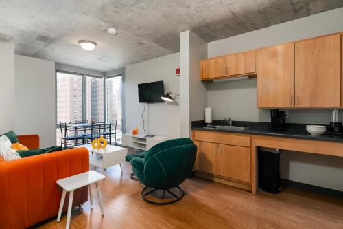 a kitchen with an orange couch and a living room at Chicago get Away in Chicago