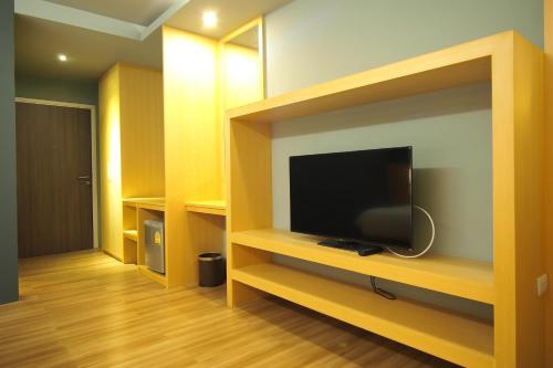 a living room with a flat screen tv on a shelf at Le Naview @Prasingh in Chiang Mai