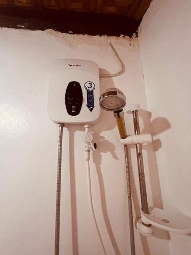 a white wall with a toilet in a room at Sunnyside Moalboal - 써니사이드 모알보알 게스트 하우스 in Moalboal