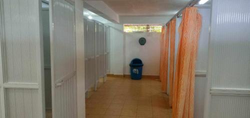 a hallway with an orange curtain and a blue trash can at MB Cove in Nasugbu