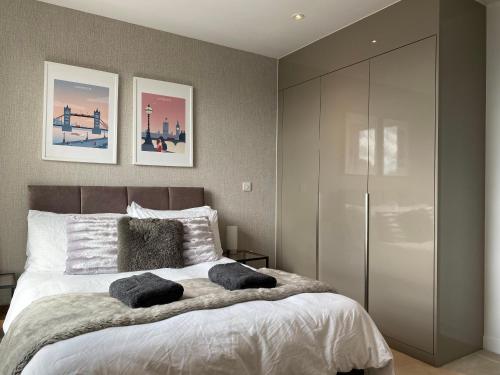 a bedroom with a bed with two pillows on it at 7th floor apartment in London