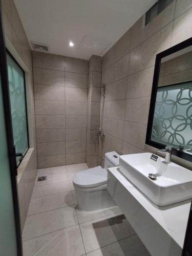 a bathroom with a white toilet and a sink at khách sạn tina 5 in Can Tho