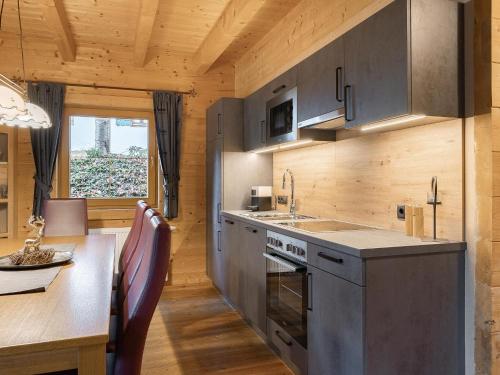 a kitchen with a counter and a table and a counter top at Chalet in Fügen near Spieljochbahn Lift in Fügen