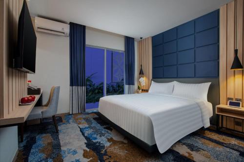 Кровать или кровати в номере ASTON Pekalongan Syariah Hotel & Conference Center